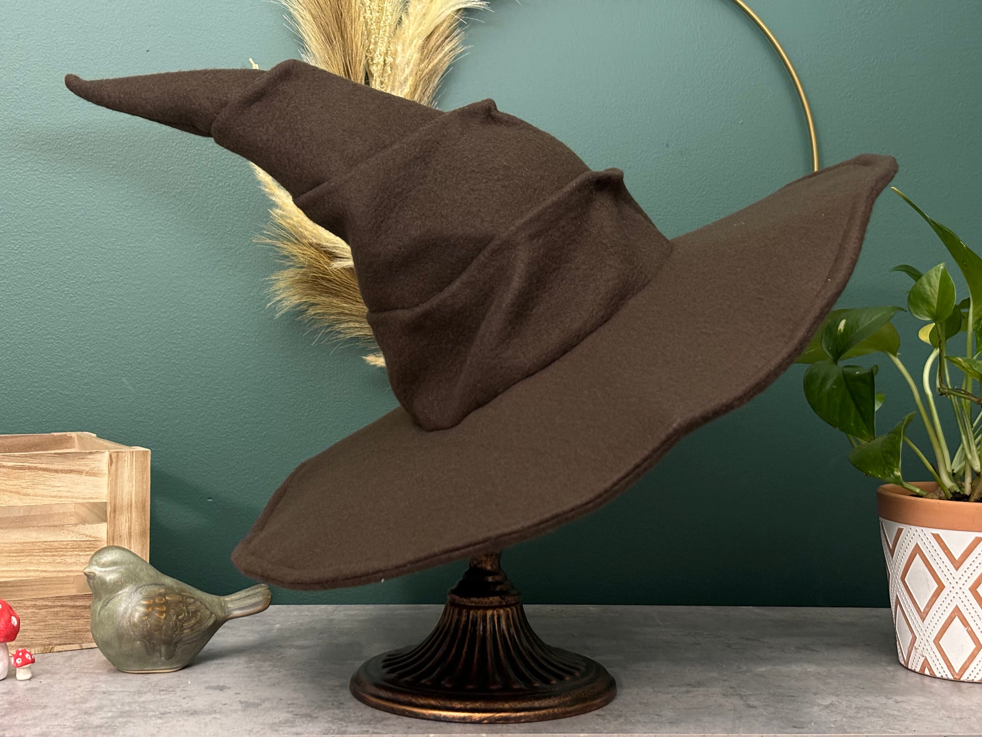 Dark brown witch hat or wizard hat made with soft fleece fabric, featuring a top cone section with three folds. The hat is customizable in various colors, including the underside of the brim, with additional fabric options available for a personalized touch.
