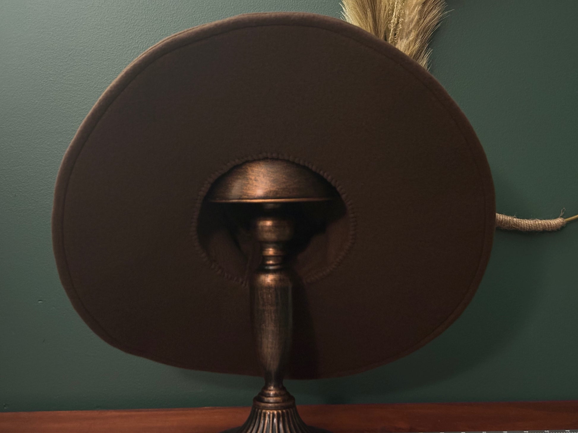 Dark brown witch hat or wizard hat made with soft fleece fabric. The hat is customizable in various colors, including the underside of the brim, with additional fabric options available for a personalized touch.